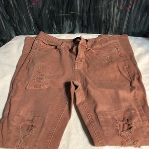 Mauve colored ripped jeans